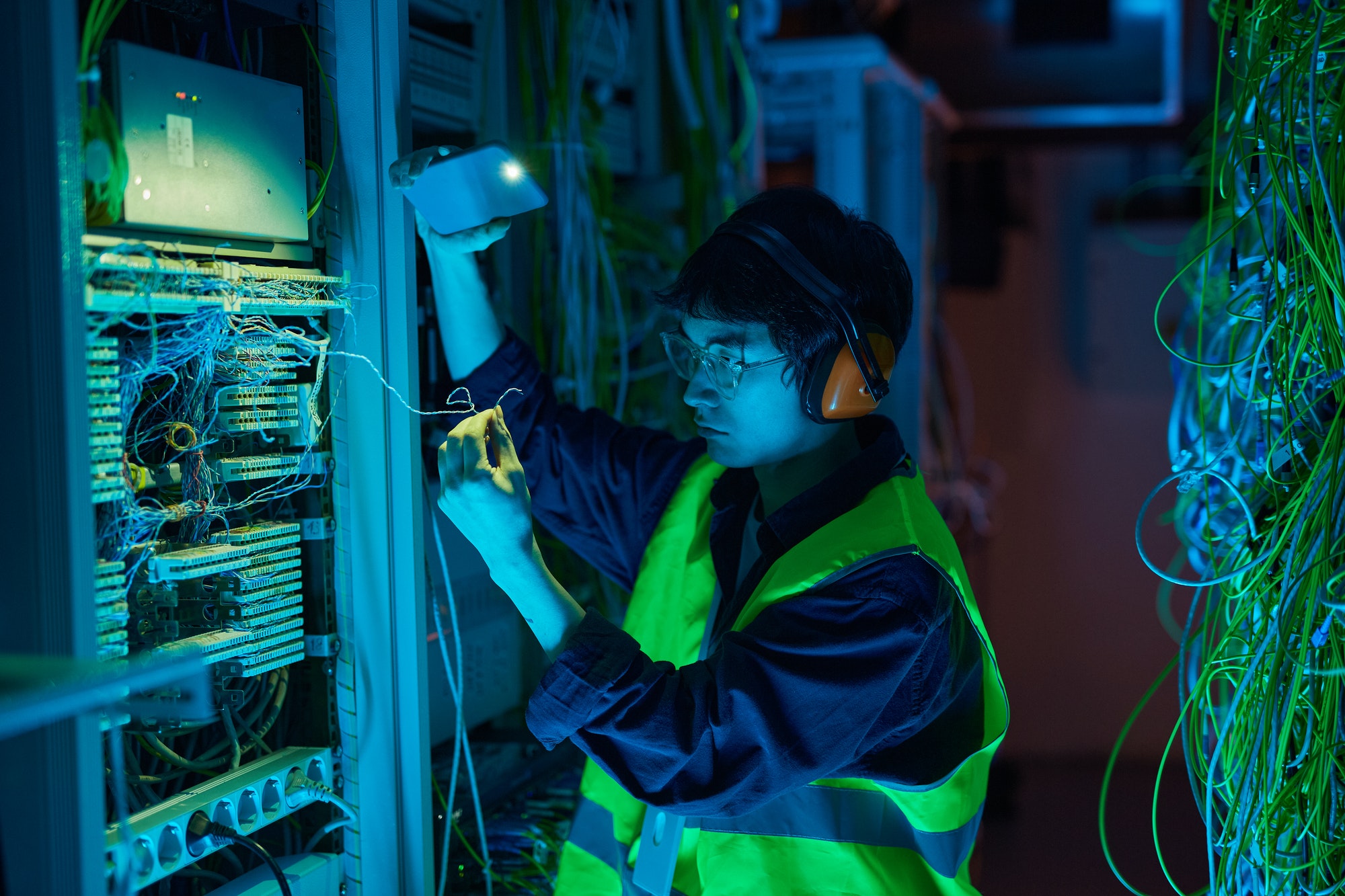 IT Technician Inspecting Server